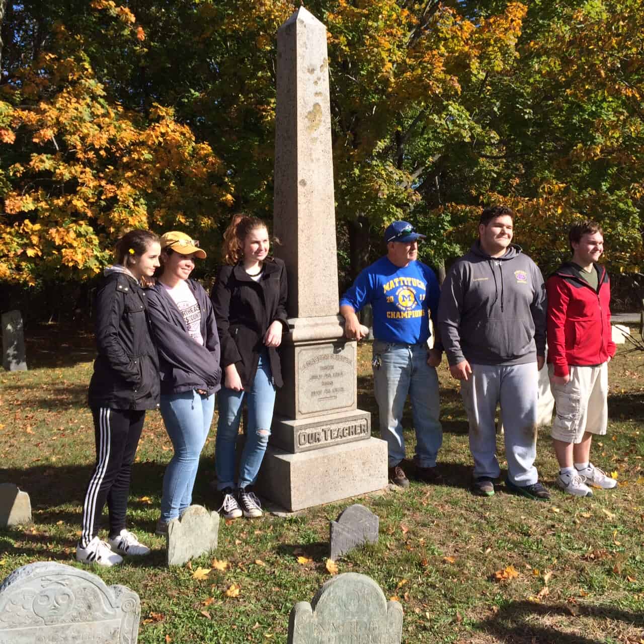 Image of people standing next to a monument